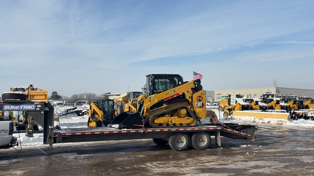 C&C Outdoor Services Cat skid steer loaded on a Sure-Trac trailer