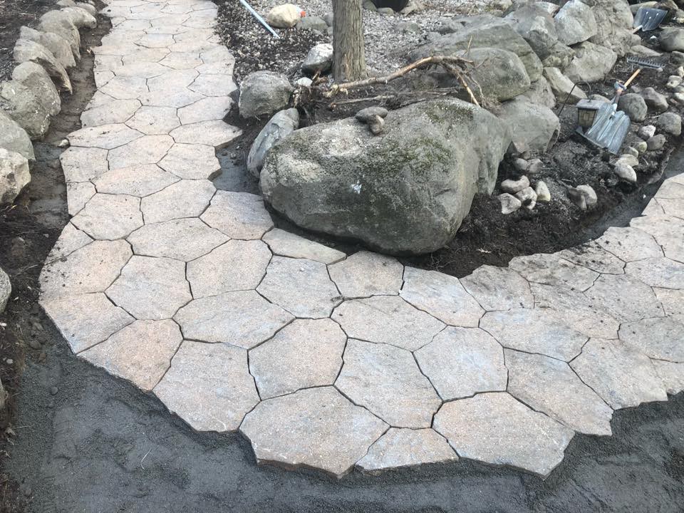 Custom flagstone paver walkway with boulder edging